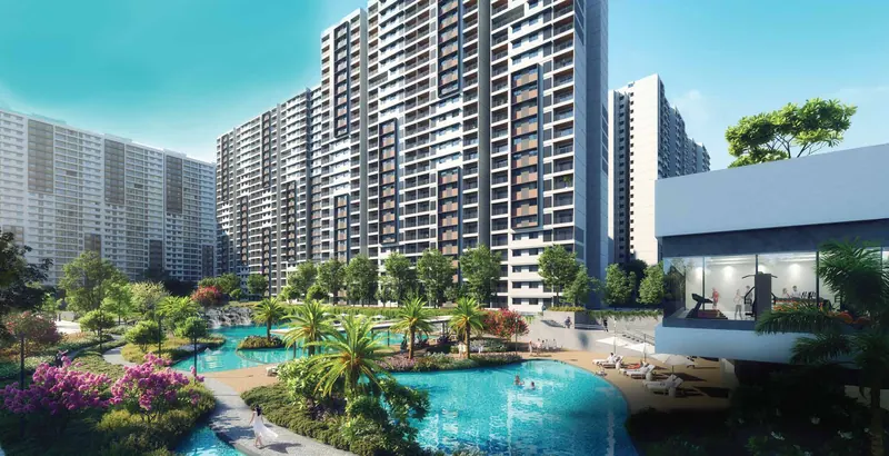 Clubhouse pool deck and lush landscape beside the towers at Adarsh Welkin Park