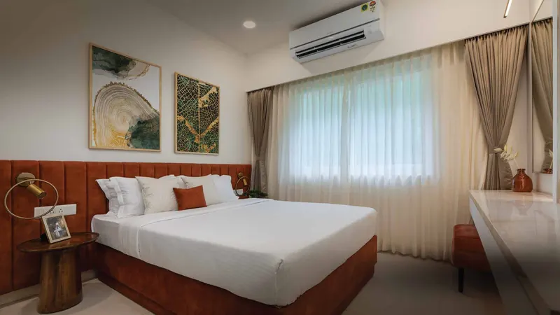 Bedroom in the Adarsh Welkin Park show apartment with an upholstered headboard