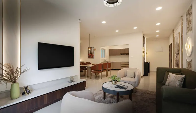 Living room of the Adarsh Welkin Park show apartment with a TV wall and lounge chairs